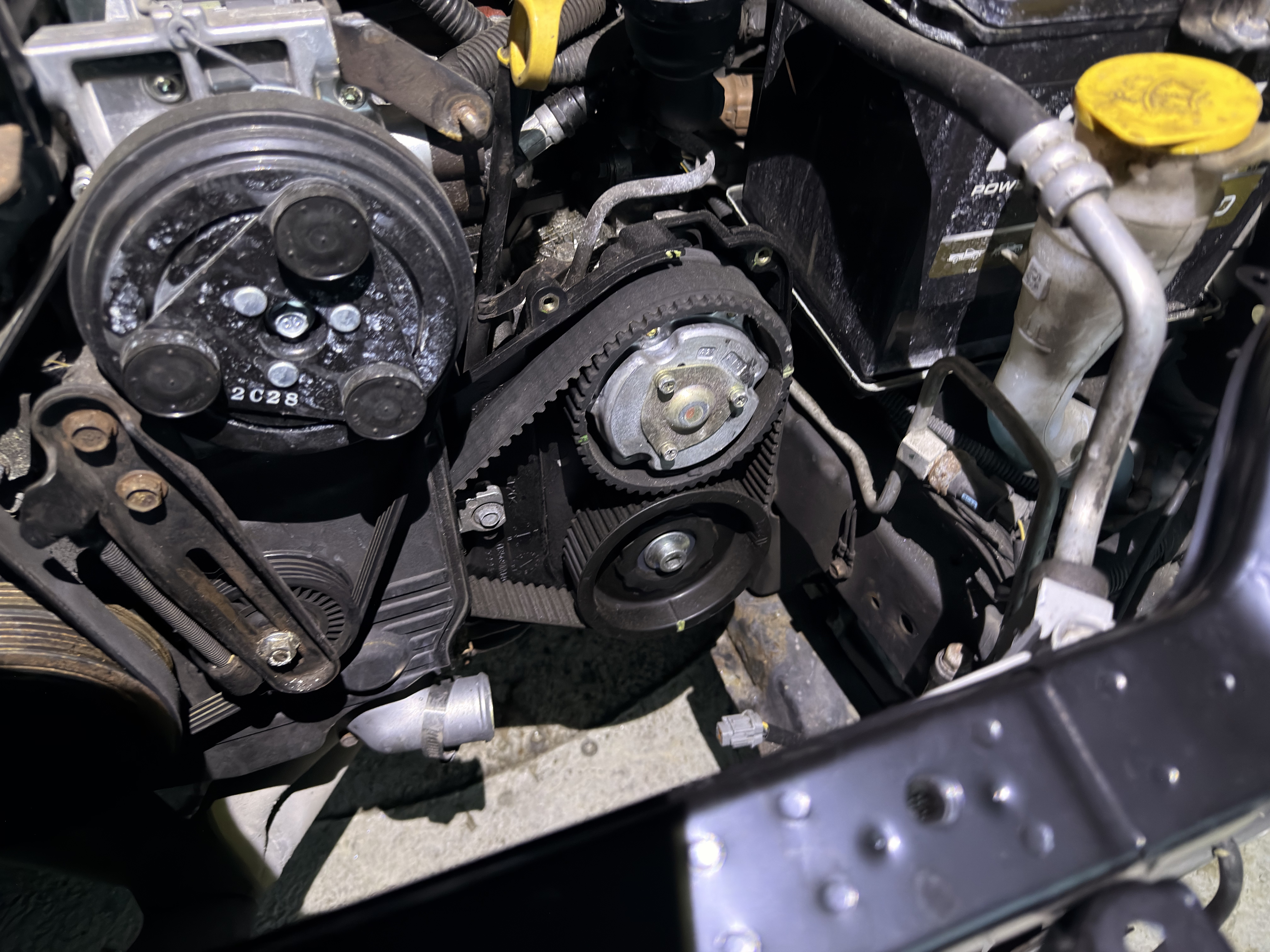 Replacing the timing belt cover that was damaged from the wreck